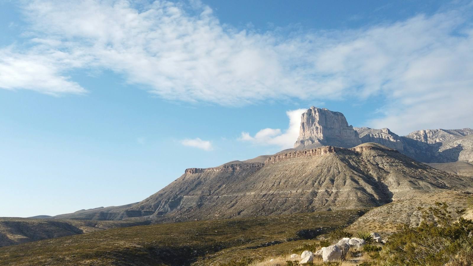 a view of a mountain with a cloud in the sky